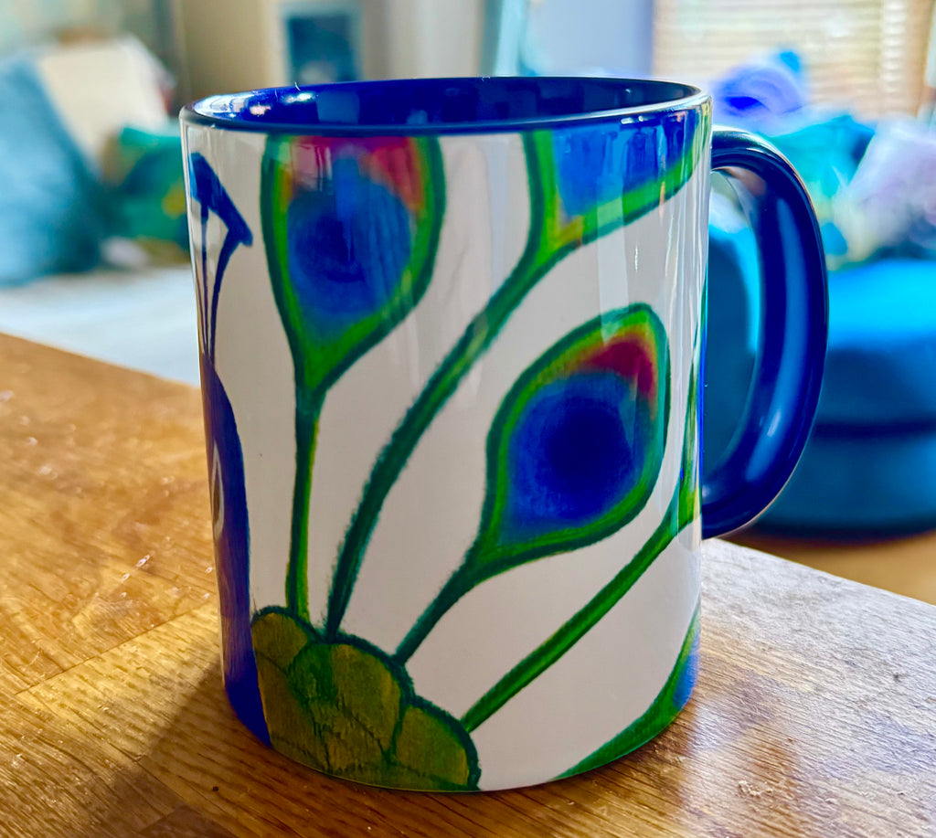 Sassy peacock coffee mug with deep blue handle and interior